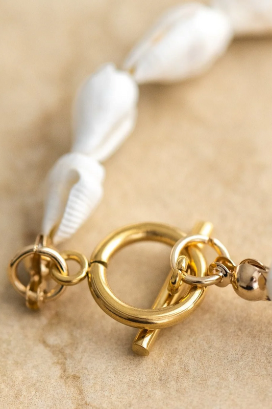 Close-up of Shelley Necklace clasp with seashells and 18Kt gold plating by Solara Boheme on neutral background