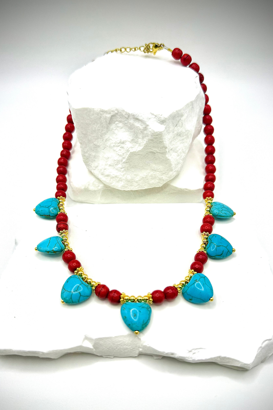 String of Hearts Necklace by Solara Boheme featuring turquoise heart beads with red and gold accents on white background.
