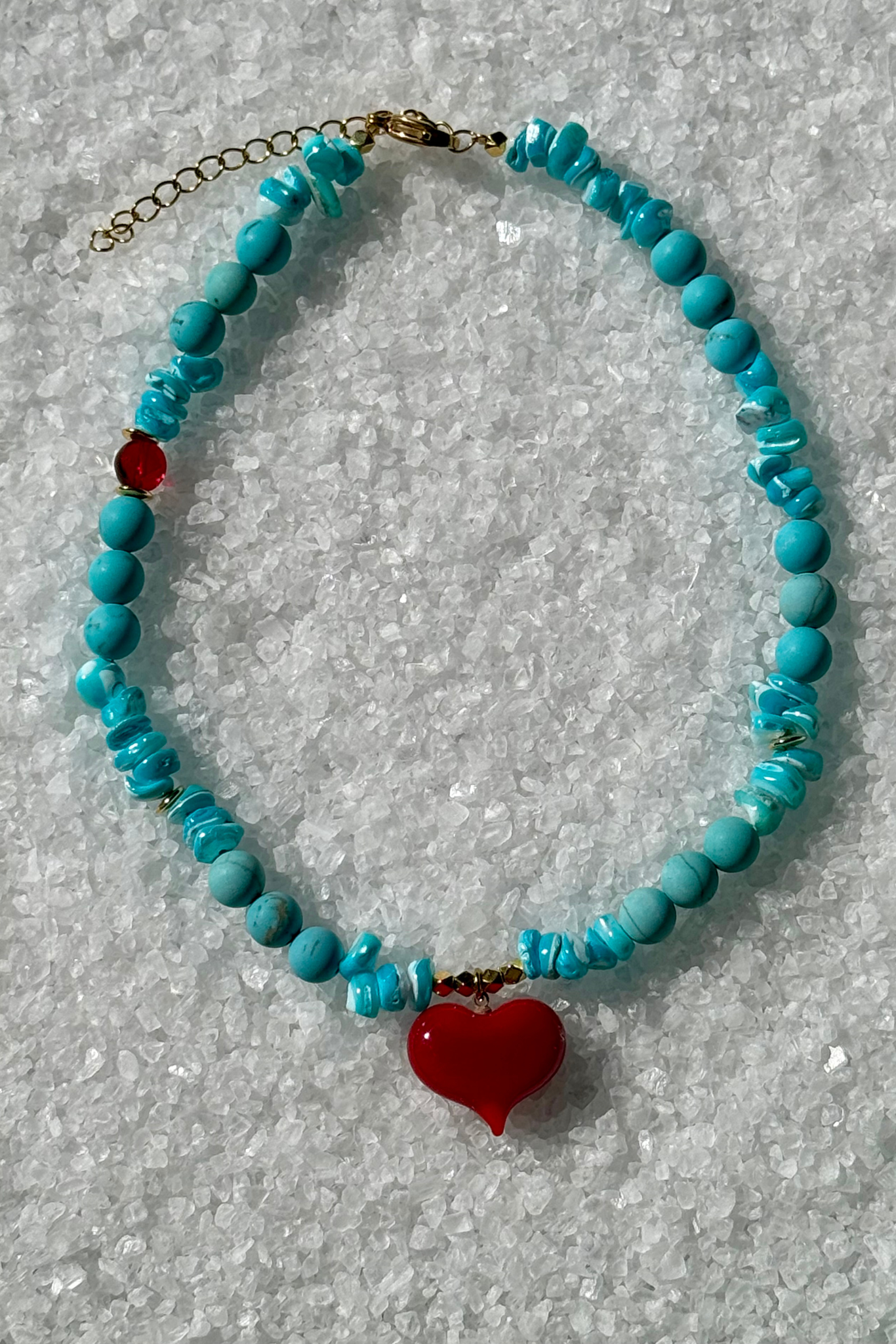 Turquoise beaded necklace with a red heart charm