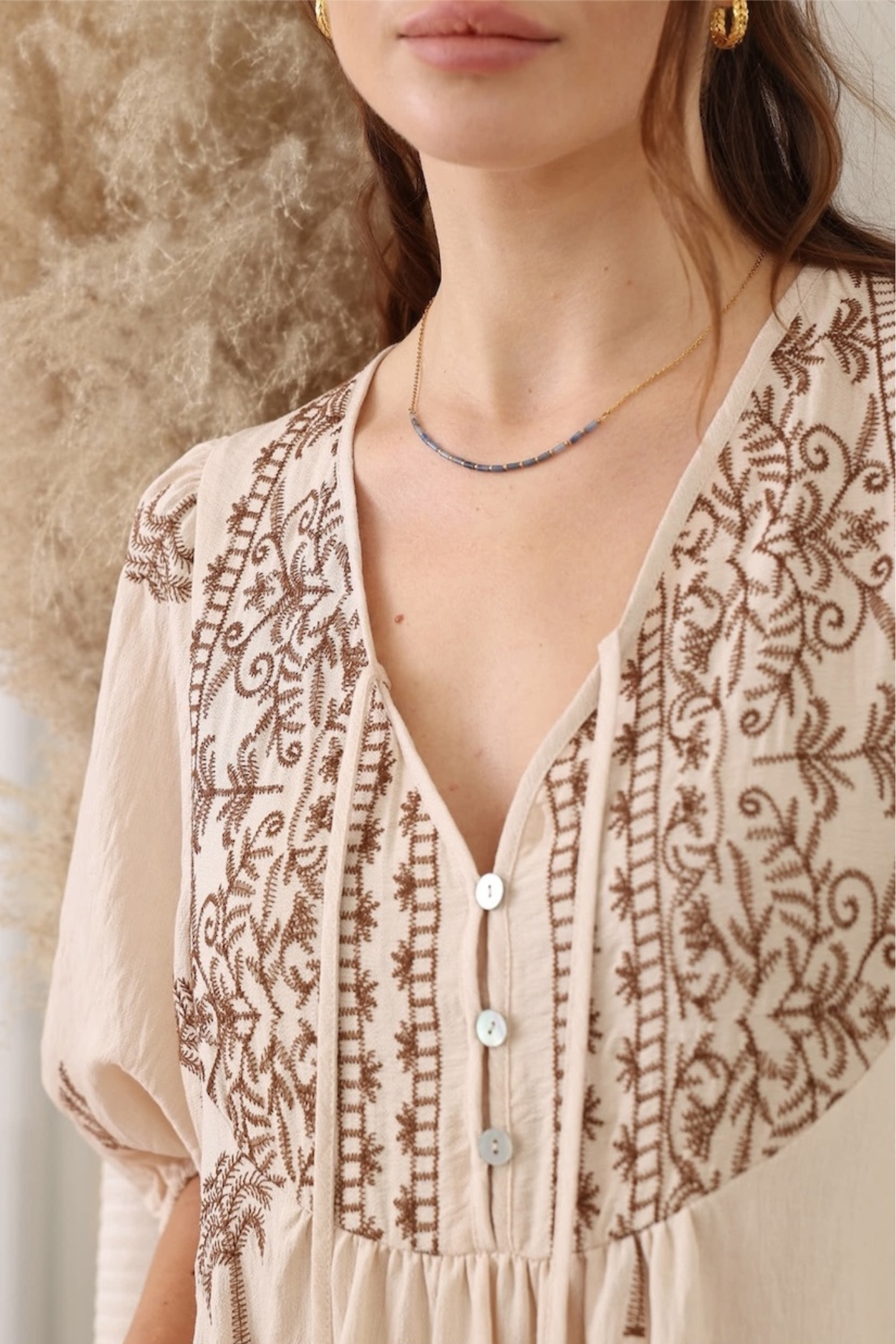 Close-up of Desert Palm Midi Dress by Solara Boheme featuring embroidered palm tree detail and button closure at bust