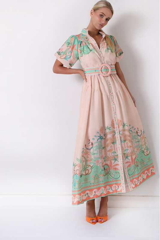 Woman wearing Solara Boheme Flamingo Coast Maxi Dress with tropical print, puff sleeves, and statement belt in soft blush tones