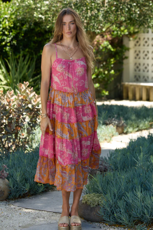 Woman wearing Solara Boheme Hip Hop Midi Dress in pink and orange paisley pattern outdoors in garden setting