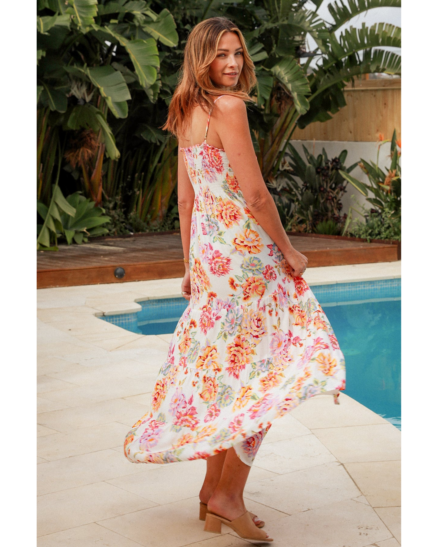 Woman wearing Lilibet Slip Maxi Dress by My Store with floral print near a pool in a tropical setting