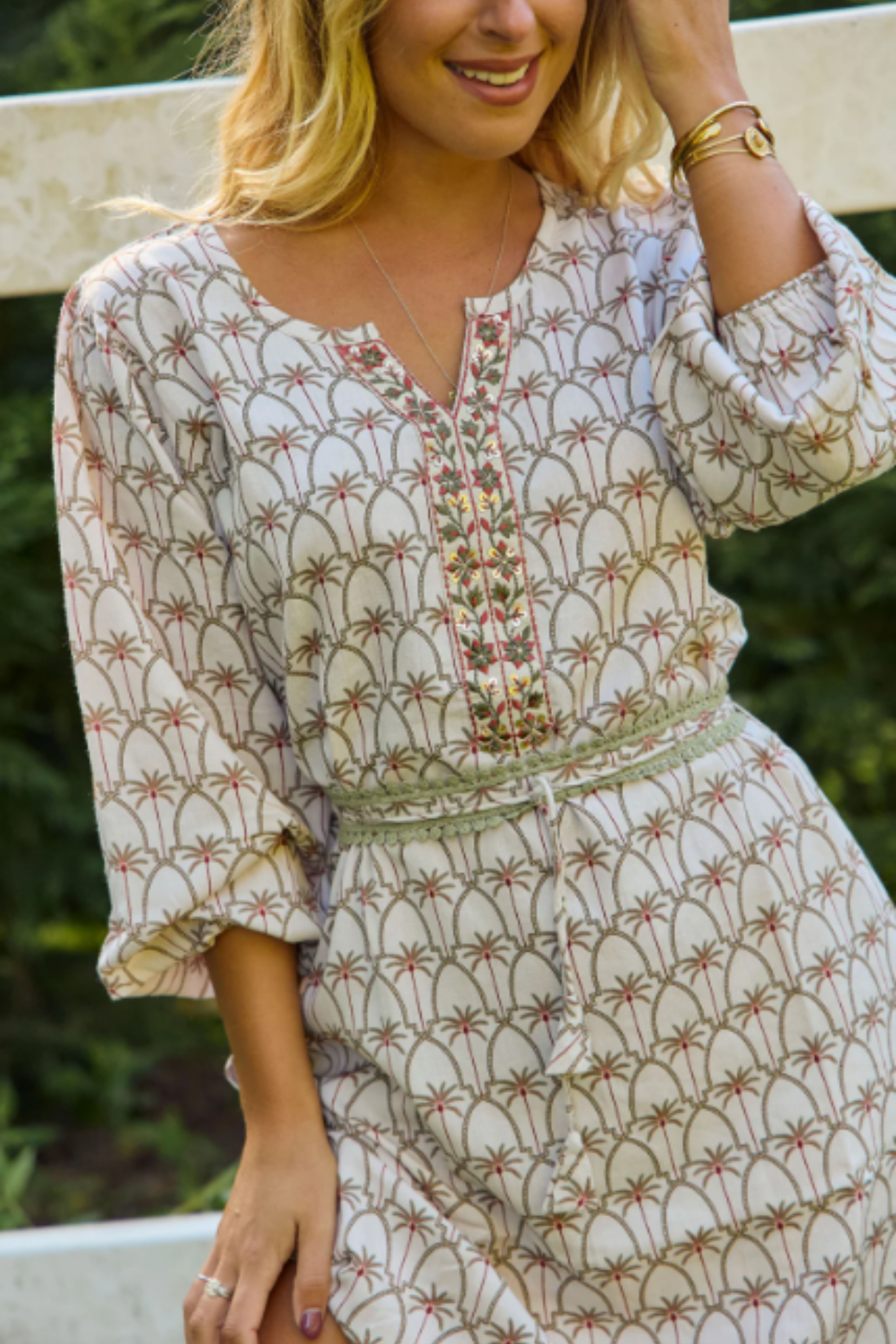Woman wearing a Palm Springs Maxi Dress by Solara Boheme with nature-inspired prints and artisanal detailing