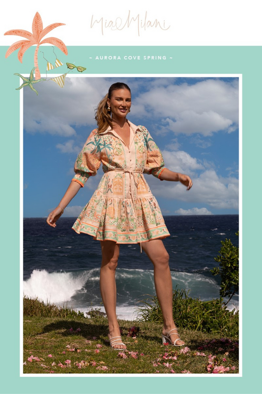 Woman wearing Palm Vista Mini Dress by Solara Boheme standing by ocean under blue sky with clouds