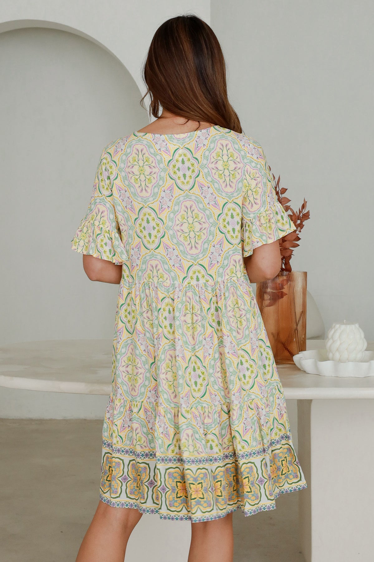 Back view of Ryder Mini Dress with pastel floral pattern, soft rayon fabric, available at My Store for comfortable wear
