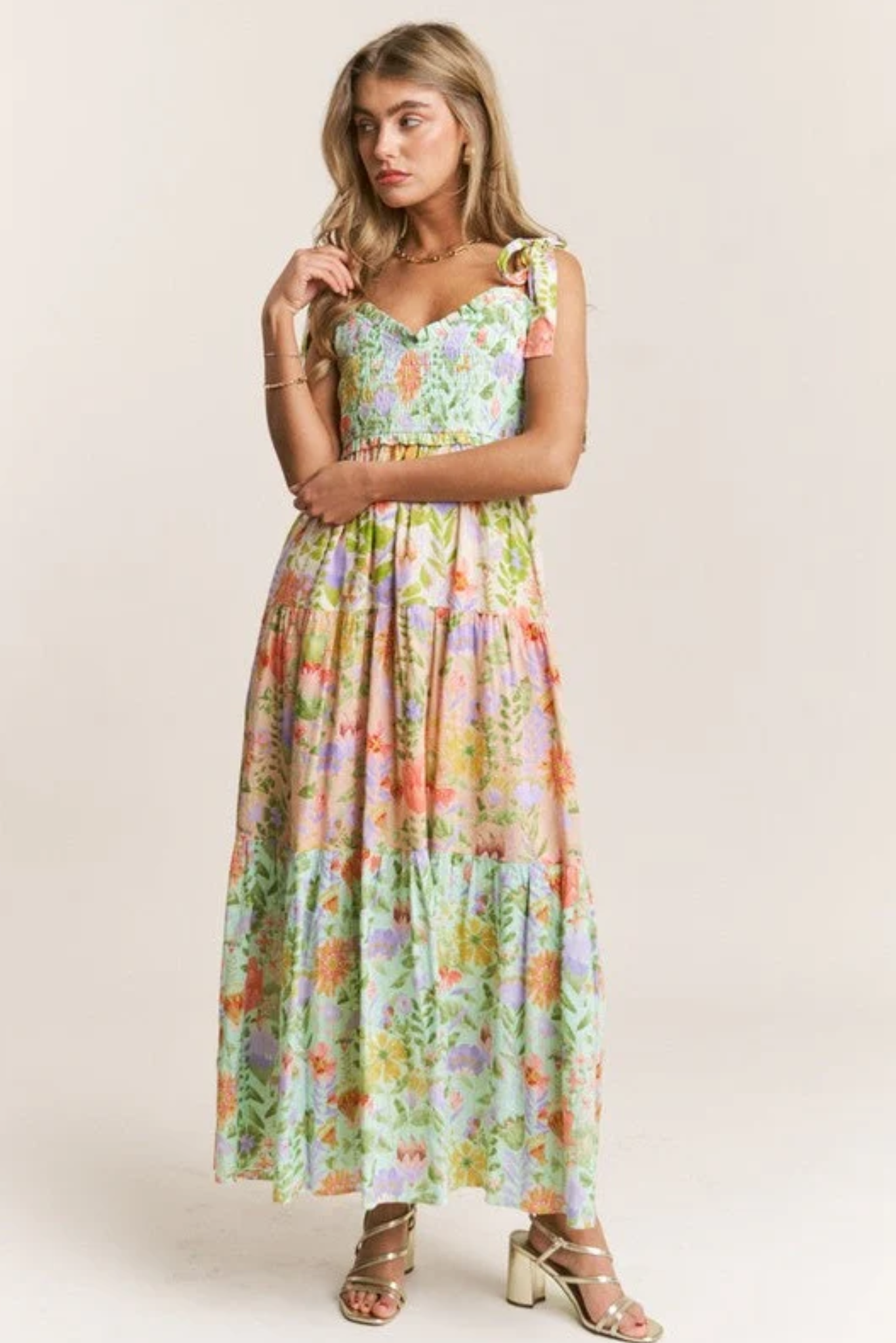 Woman wearing a floral dress on a plain background