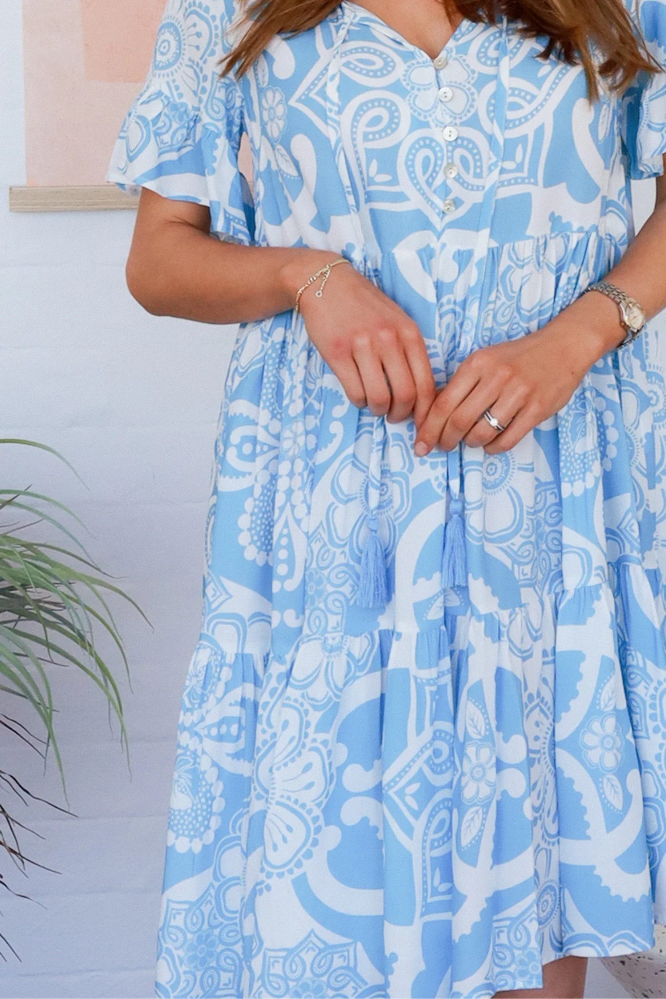 Solara Boheme Stella Mini Dress in sky blue with white print, flutter sleeves and button-front detail.