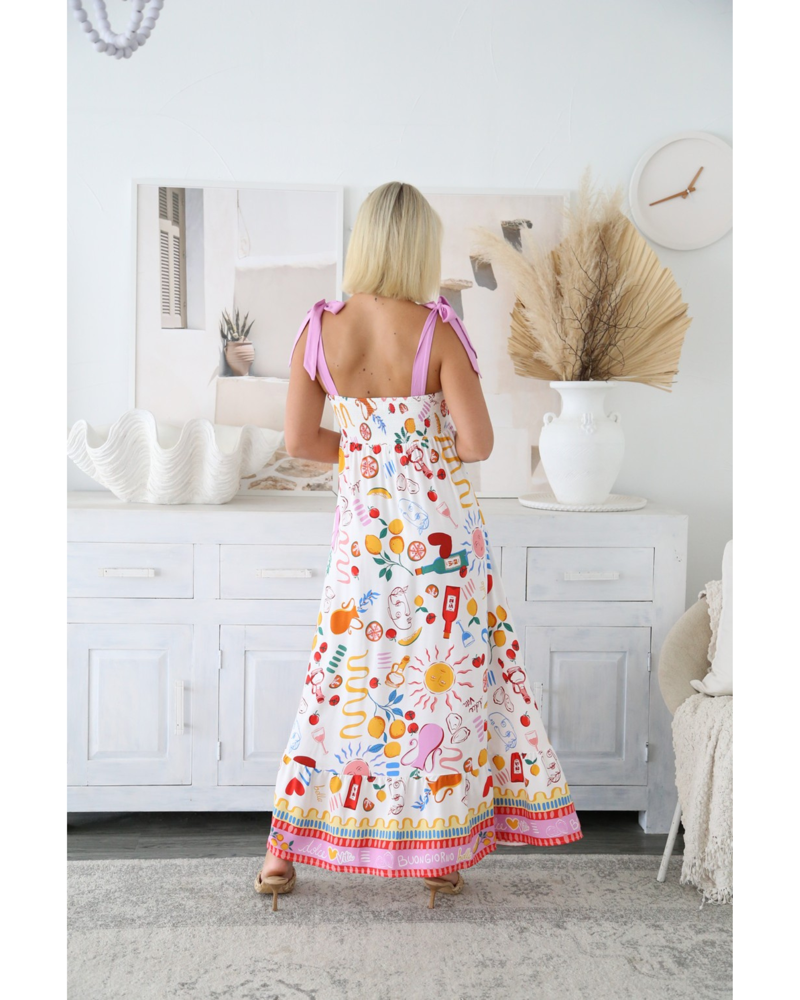 Back view of woman wearing Sunprint Maxi Dress with adjustable straps by My Store in bright patterned fabric