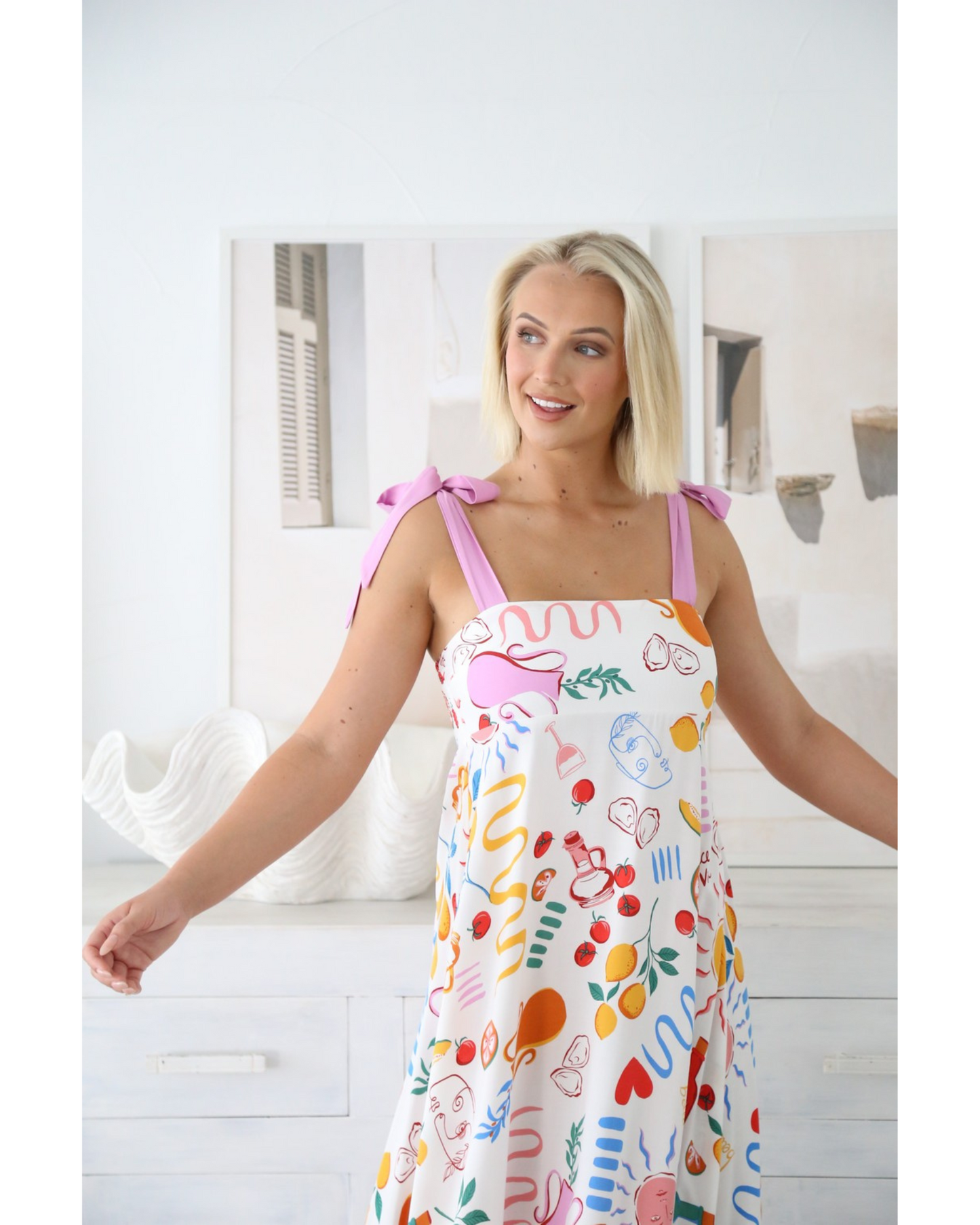 Woman wearing the Sunprint Maxi Dress by My Store featuring square neckline and colorful print design