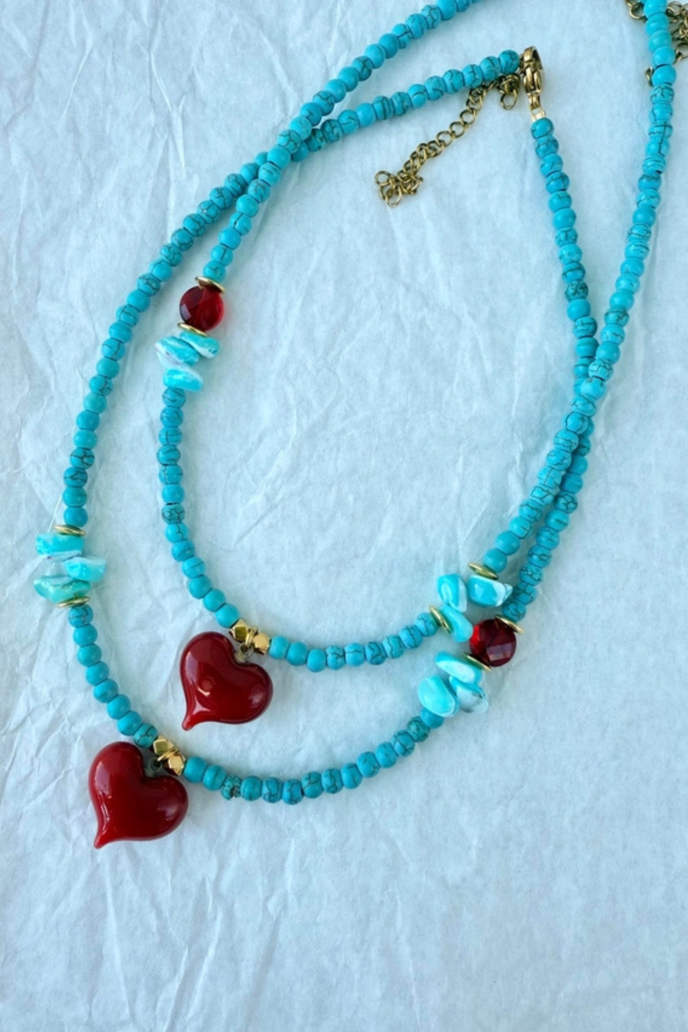Turquoise beaded necklace with red heart pendant