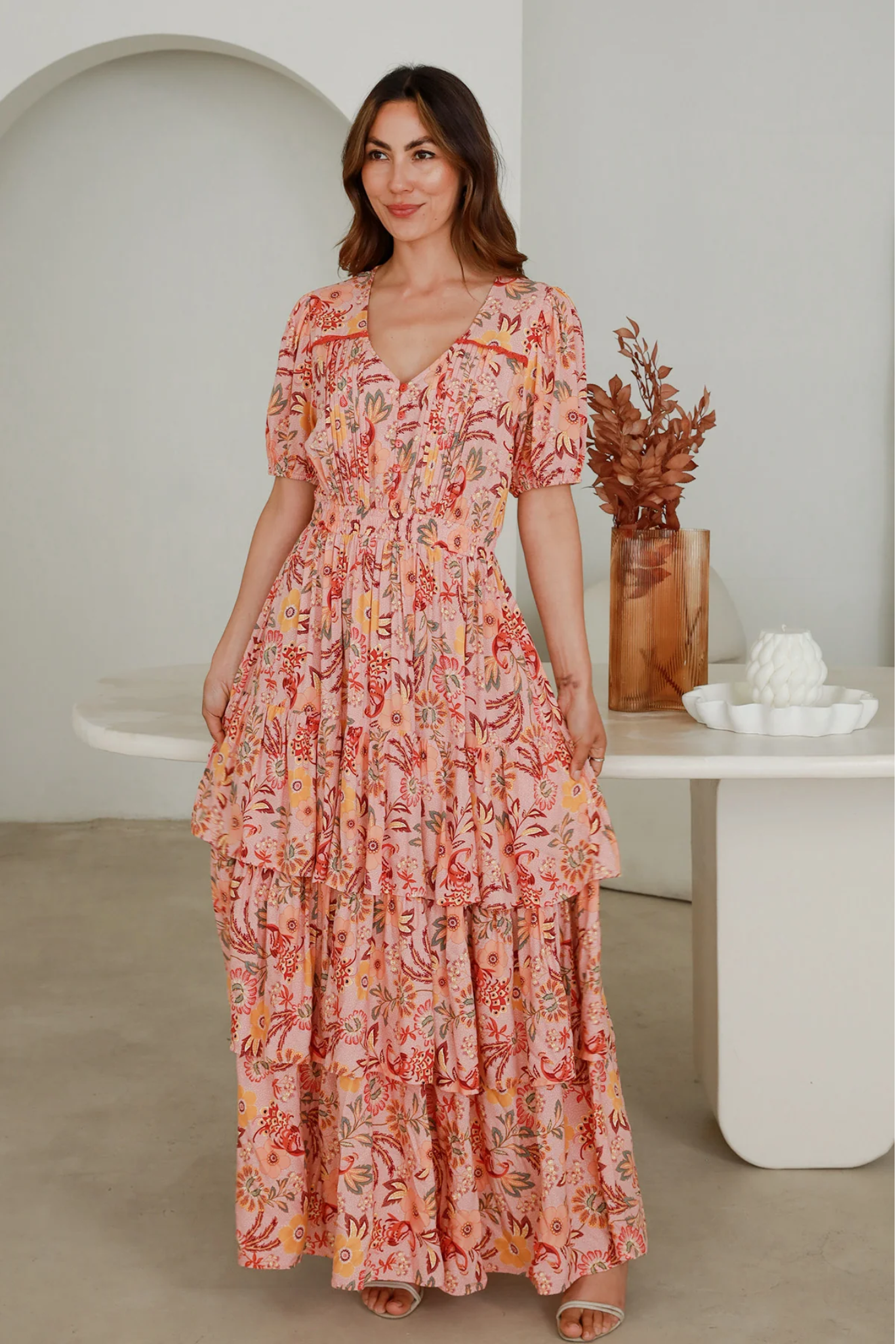 Woman wearing Solara Boheme Vera Maxi Dress in soft rayon with floral print and tiered skirt in an indoor setting