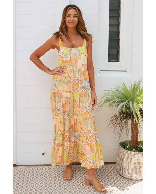 Woman wearing Xena Slip Maxi Dress by My Store standing indoors near a window and potted plant